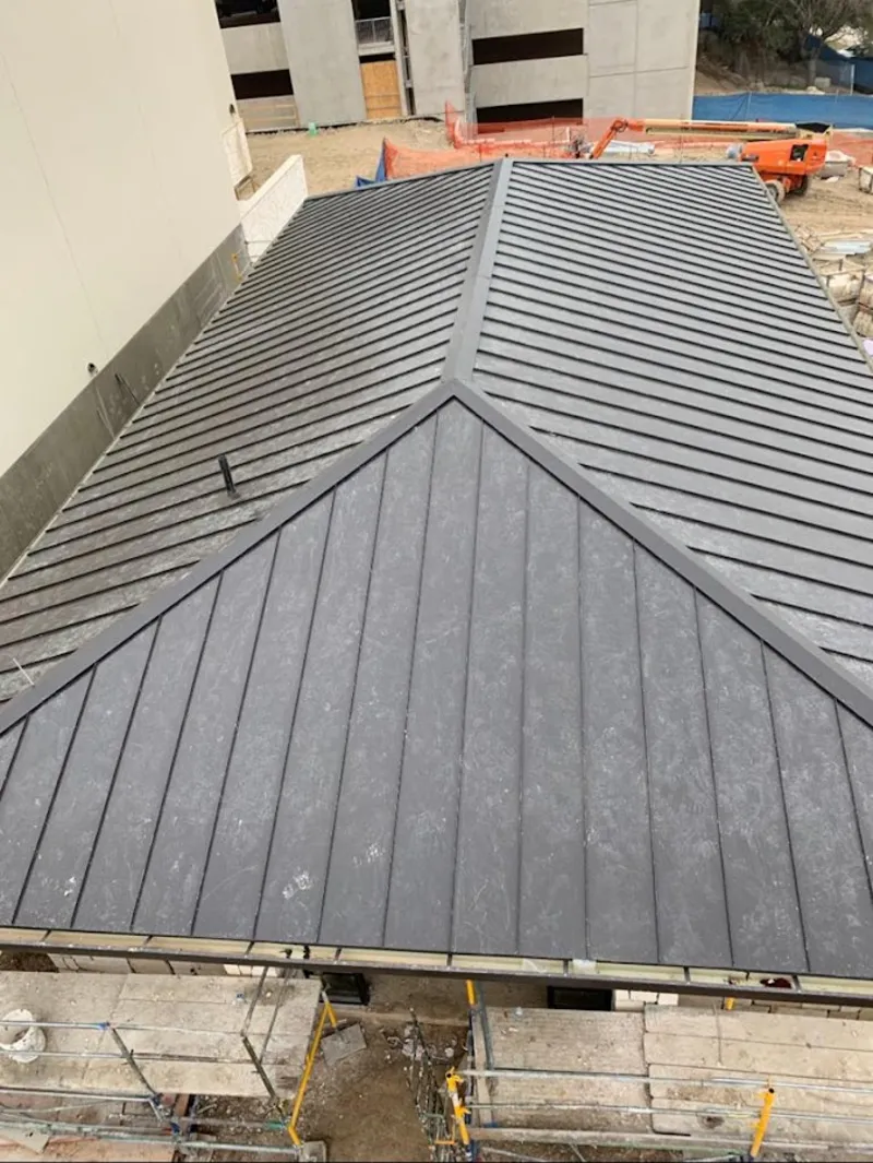 Commercial metal roof construction with crane equipment in Withamsville